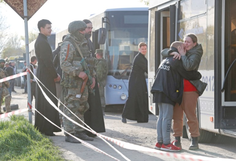 Azovstal steel plant employee Valeria, last name withheld, evacuated from Mariupol, hugs her son Matvey, who had earlier left the city with his relatives, as they meet at a temporary accommodation centre in the village of Bezimenne in the Donetsk Region.