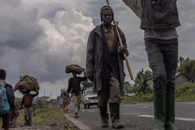 Batu Banyeho,77, walks after being displaced by clashes between the Congolese army and the M23 rebels in Kibumba.