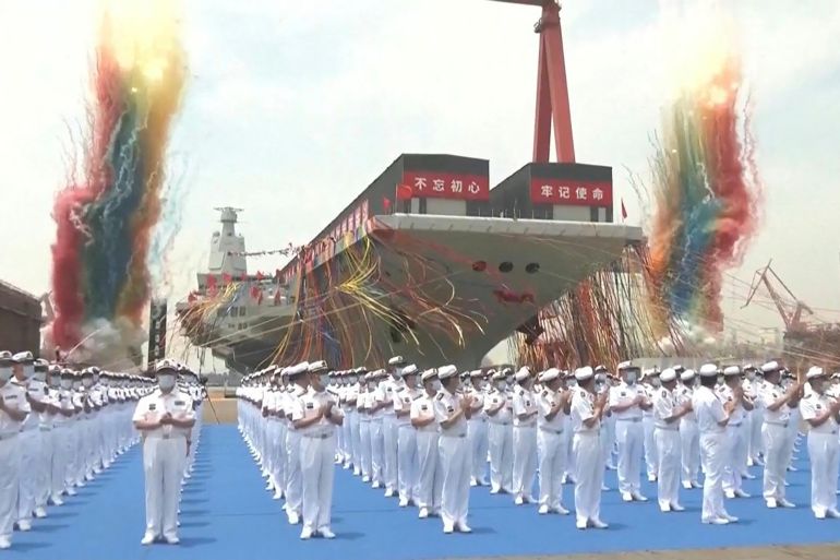 Massed troops at a ceremony to mark the launch of China's third aircraft carrier at a dock in Shanghai