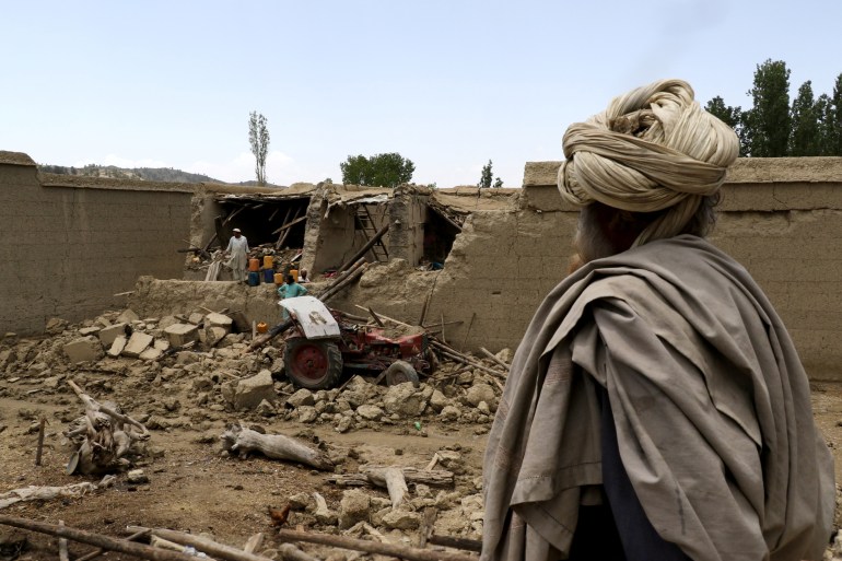 Afghan men examine the damage to their houses after a recent earthquake in Gayan, Afghanistan, June 23, 2022 [Reuters]