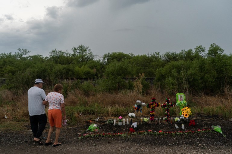 Residents pay a visit to mourn the victims at the scene where dozens of refugees and migrants were found dead inside a trailer truck in San Antonio, Texas.