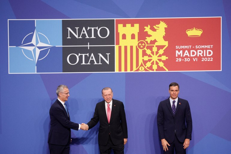 NATO Secretary General Jens Stoltenberg, Turkish President Tayyip Erdogan and Spanish Prime Minister Pedro Sanchez pose for a photo during a NATO summit in Madrid, Spa