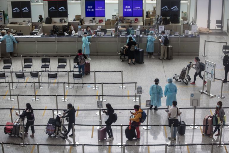 Medical staff oversee travel queues in airport