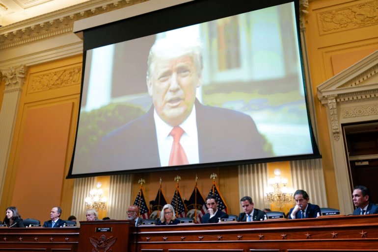 Trump on a big screen over the heads of committee members investigating the January 6, 2021 Capitol attack