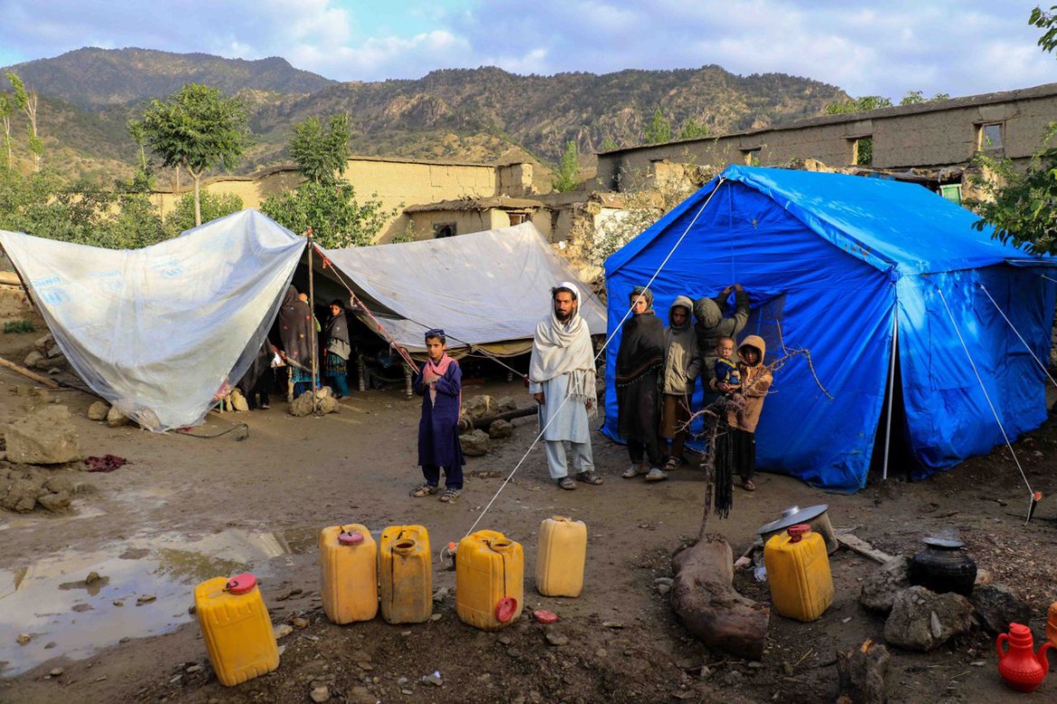 fghans sit outside the temporary shelter after an earthquake in Gayan village in Paktia province, Afghanistan, 23 June 2022. More than 1,000 people were killed and over 1,500 others