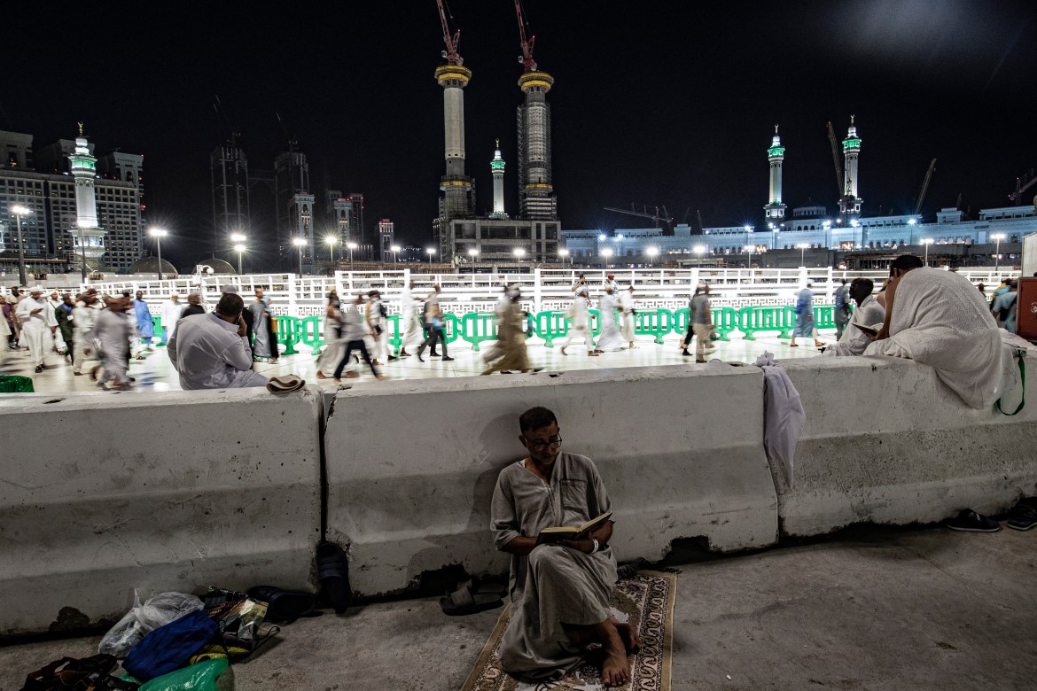 A Muslim worshipper reads from the Holy Koran at the Grand Mosque