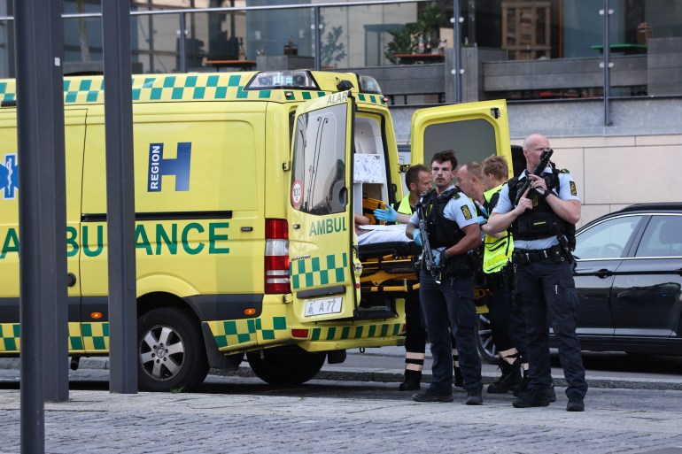 An ambulance and armed police stand outside Field's shopping centre in Copenhagen, Denmark.