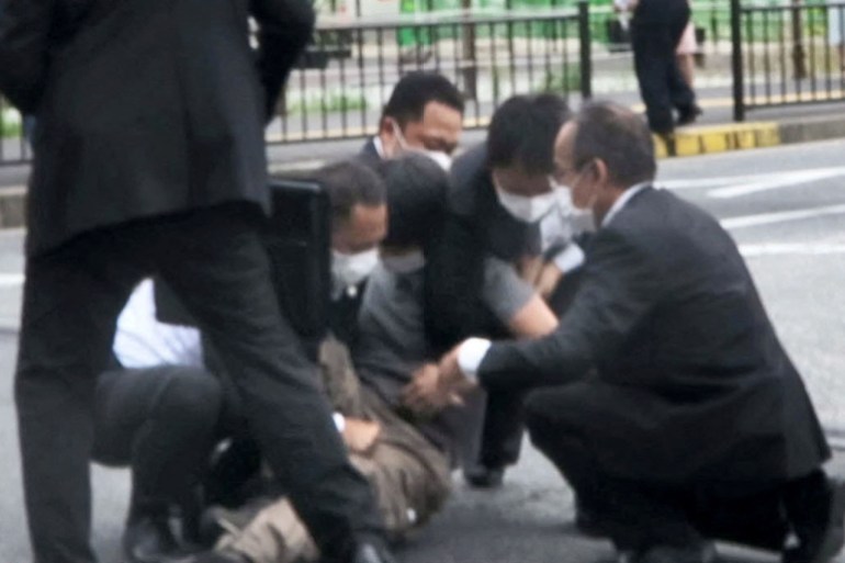 This screen grab shows a man being detained near the location where former Japanese Prime Minister Shinzo Abe was shot in Nara