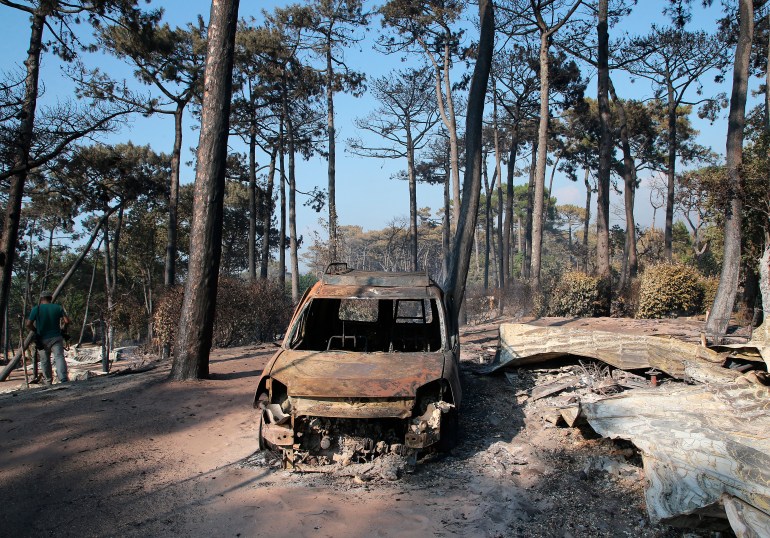 A burnt out car is seen at Les Flots Bleus camping site in Pyla sur Mer, near Arcachon, southwest France