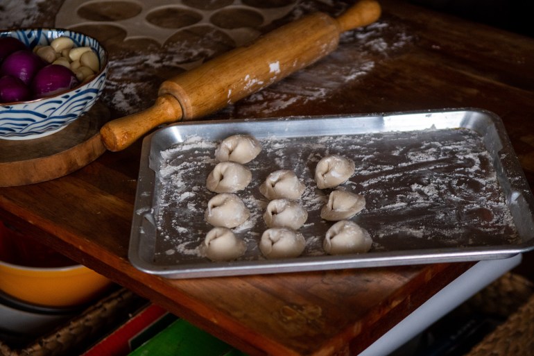 Meat filled pelmeni on a tray ready for the pot