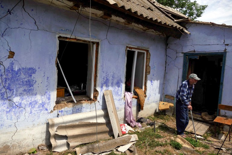 A local resident stands next to a house damaged by a Russian missile in the village of Maiaky, in Odesa region, Ukraine June 27, 2022