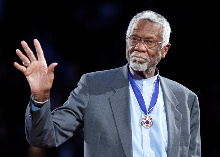 Boston Celtics' great Bill Russell stands with his Presidential Medal of Freedom