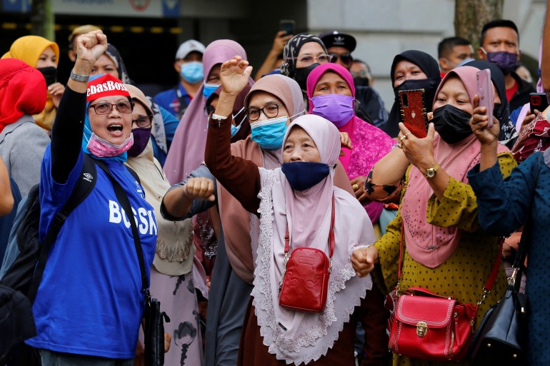 Supporters of former Malaysian Prime Minister Najib Razak shout slogans outside the Federal Court, in Putrajaya, Malaysia.