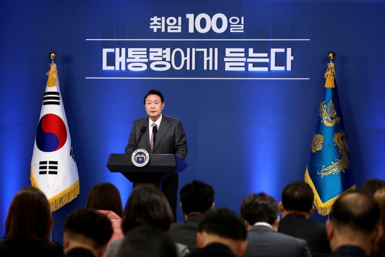 South Korean President Yoon Suk Yeol on stage delivering an update on his 100 days in office