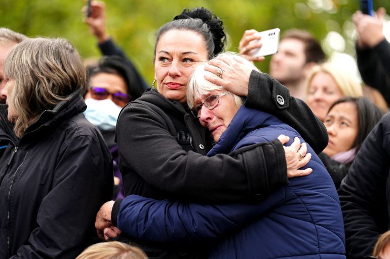 People embrace during the funeral of Britain's Queen Elizabeth II.