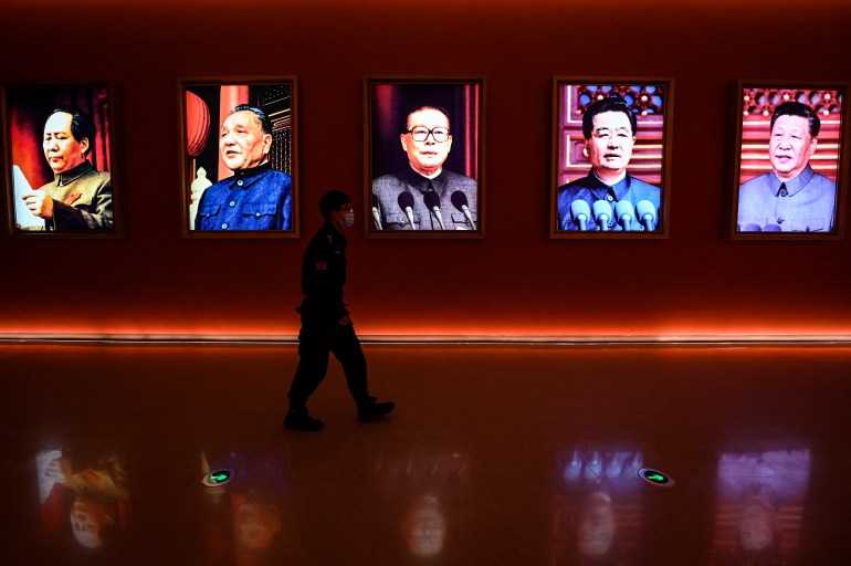 A man walks past portraits of late Chinese chairman Mao Zedong and former Chinese leaders Deng Xiaoping, Jiang Zemin, Hu Jintao and current president Xi Jinping at Yan'an Revolutionary Memorial Hall in Yan'an city, China.