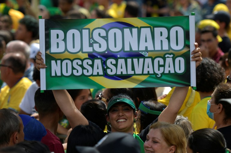A supporter of Bolsonaro holds a sign during a rally in Brazil