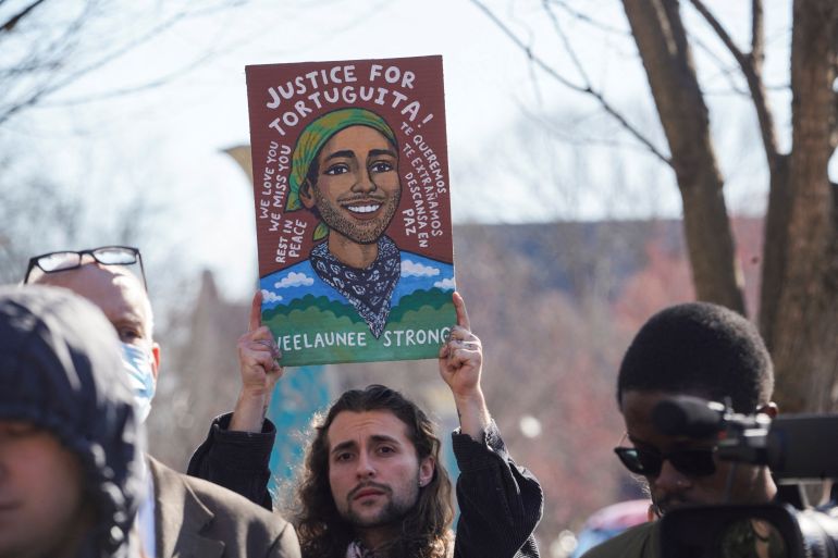 An Atlanta activist holds a sign demanding justice for environmental activist Manuel Teran, killed by police in Atlanta, US