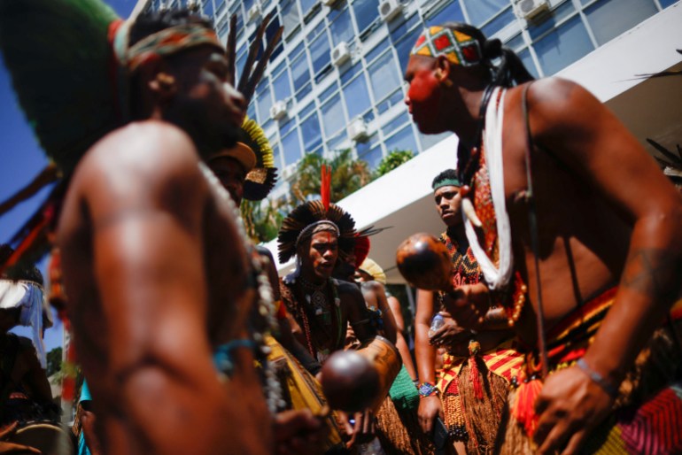 Indigenous people take part in a protest demanding government action to address the health crisis in their territories in Brazil