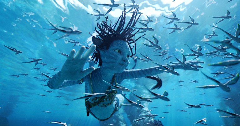 A film still of Avatar: Way of Water, showing a character underwater swimming