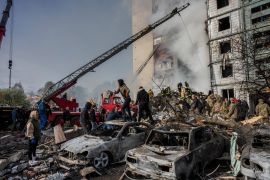 Following a Russian attack, first responders remove rubble at a residential building in Uman, central Ukraine, Friday, April 28, 2023. (AP Photo/Bernat Armangue)