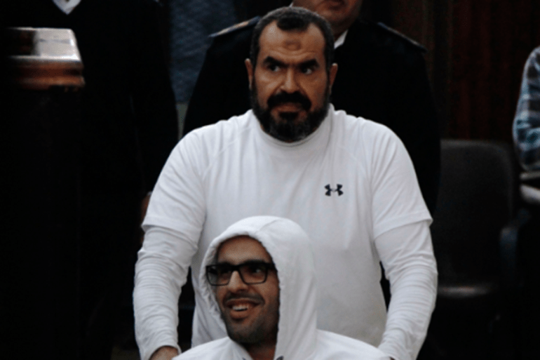 Mohamed Soltan, a dual U.S.-Egyptian citizen, is pushed by his father Salah.