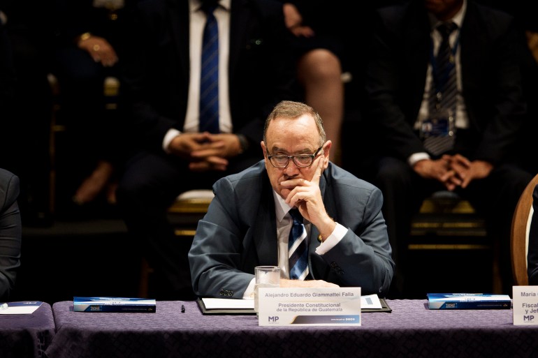 Guatemalan President Alejandro Giammattei listens to the first annual report of the second four-year term of Attorney General Consuelo Porras in Guatemala City, Wednesday, May 17, 2023.