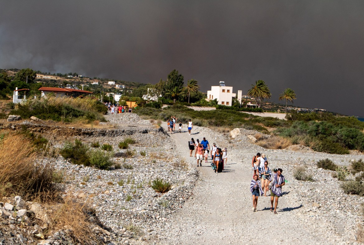 general Tourists are being evacuated as wildfire burns plan Lindos