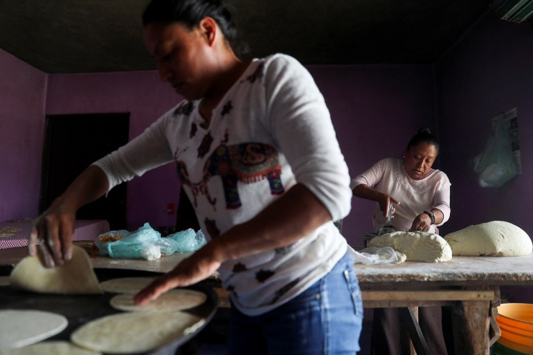 Women prepare dough to make tortillas in a family tortilla factory at La Constitucion Totoltepec neighbourhood, in Toluca, Mexico