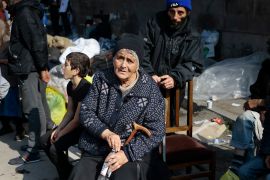 Ethnic Armenians from Nagorno-Karabakh sit next to their belongings near a tent camp after arriving to Armenia&#039;s Goris in Syunik region, Armenia [File: Vasily Krestyaninov/AP Photo]
