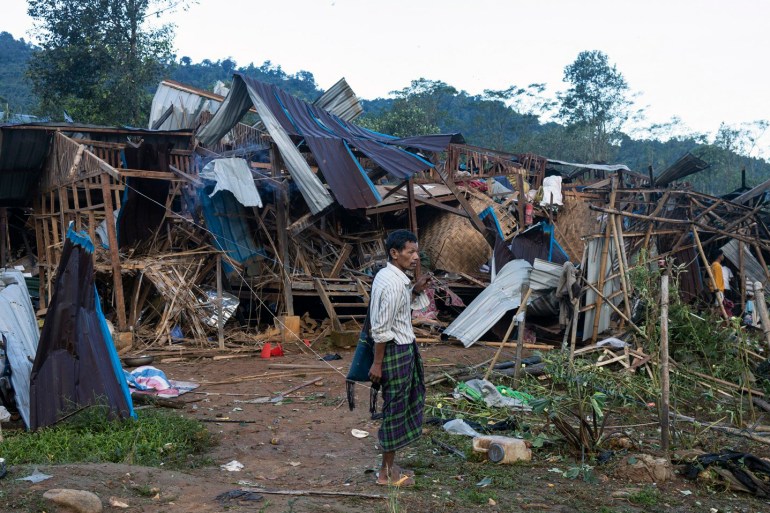 A man looking at homes destroyed in military attacks in northern Kachin state