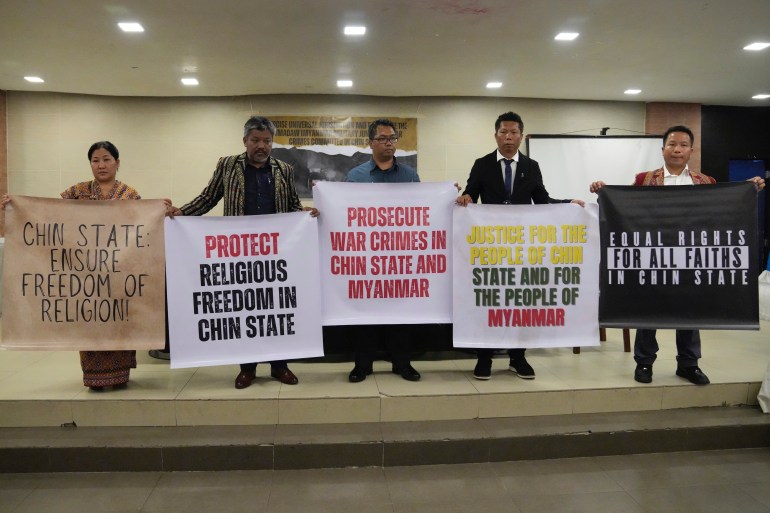 Families hold posters calling for protection of ethnic Chin civilians from Myanmar