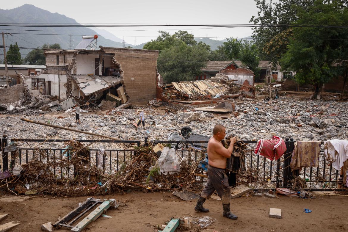Mr. Sun recovers belongings from his house following strong rains and floods in the mountains of Mentougou District, west of Beijing, China.