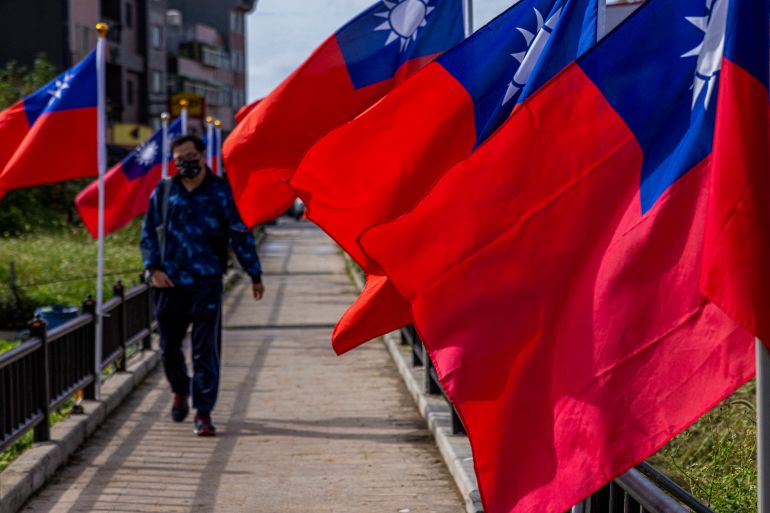 A man walking past the flags of Taiwan
