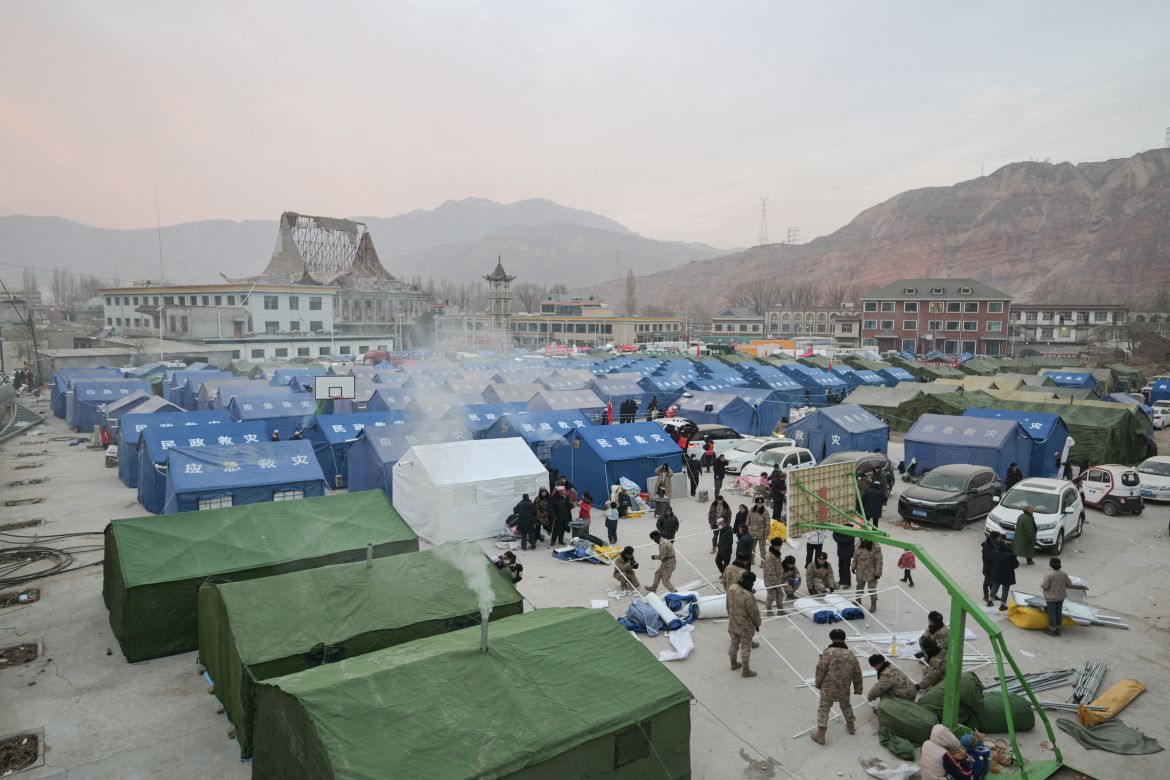 People are seen at a temporary shelter in the main square in Dahejia in Jishishan County in northwest China's Gansu province.