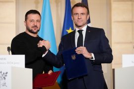 French President Emmanuel Macron (right) and Ukraine&#039;s Volodymyr Zelenskyy are pictured after signing a security pact calling for French military and civilian aid for Kyiv [File: Thibault Camus/Pool/AFP]
