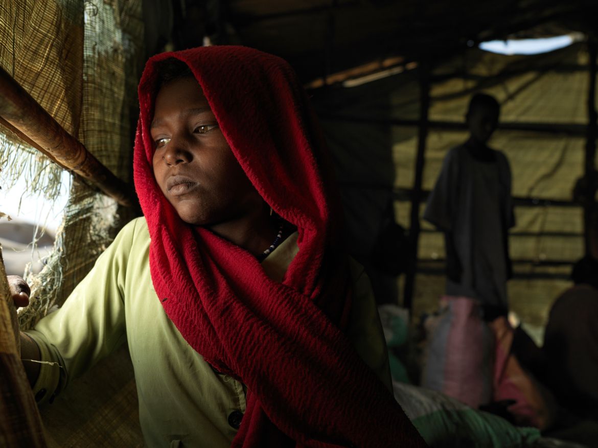 Niehmo, 10, sits in his shelter at the Renk transit centre, provided by Plan International.
