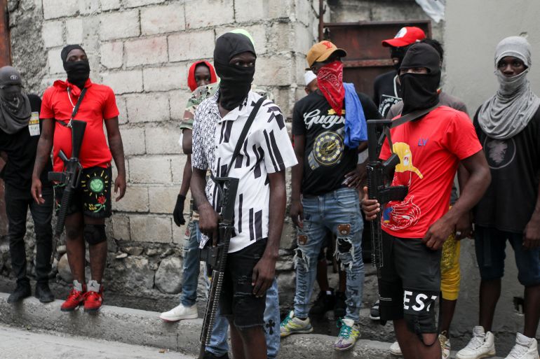 Haitian gang members provide security to Jimmy 'Barbecue' Cherizier, head of the G9 gang coalition, in Port-au-Prince