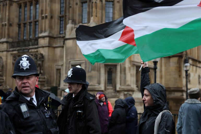 Police officers keep watch as campaigners queue to lobby MPs in Parliament ahead of a debate to hold a vote for a ceasefire in Gaza, amid the ongoing conflict between Israel and the Palestinian Islamist group Hamas, in London, Britain, February 21, 2024. REUTERS/Isabel Infantes
