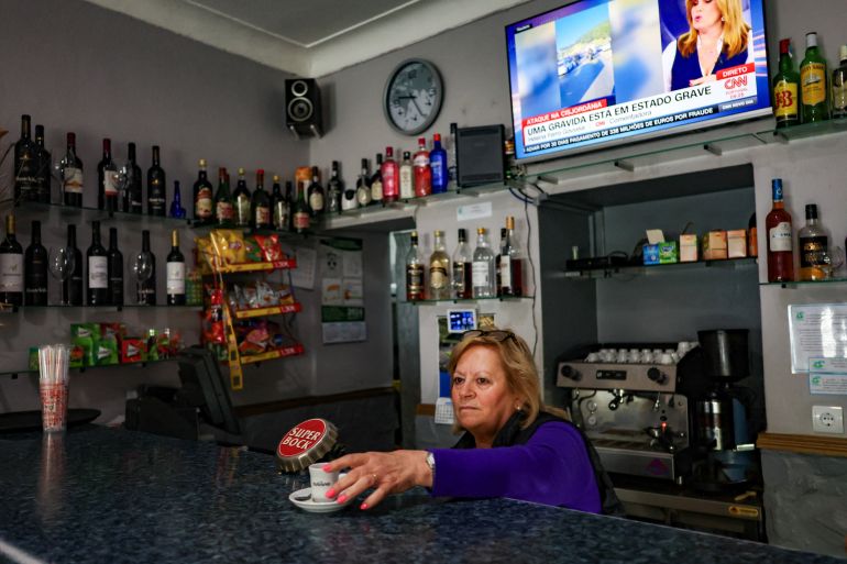 A woman holds a cup of coffee at a coffee shop in Sao Vicente e Ventosa, where in 2022 Chega garnered the highest share of votes in a Portuguese civil parish - 28.3% - four times its national result then, in Elvas, Portugal, February 22, 2024. REUTERS/Pedro Nunes