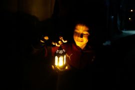 A child holds a lantern as displaced Palestinians prepare their tents for Ramadan, amid the ongoing conflict between Israel and the Palestinian Islamist group Hamas, in Rafah, in the southern Gaza Strip March 9, 2024