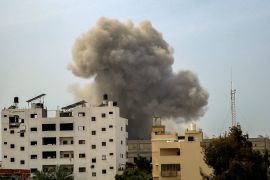 Smoke rises above buildings from an Israeli strike near al-Shifa Hospital in Gaza City on March 28, 2024[AFP]