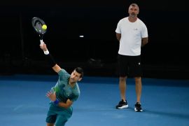 Serbia’s Novak Djokovic serves as his coach Goran Ivanisevic watches during a practice session at the 2024 Australian Open tennis championships In Melbourne, Australia. [Andy Wong/AP Photo]