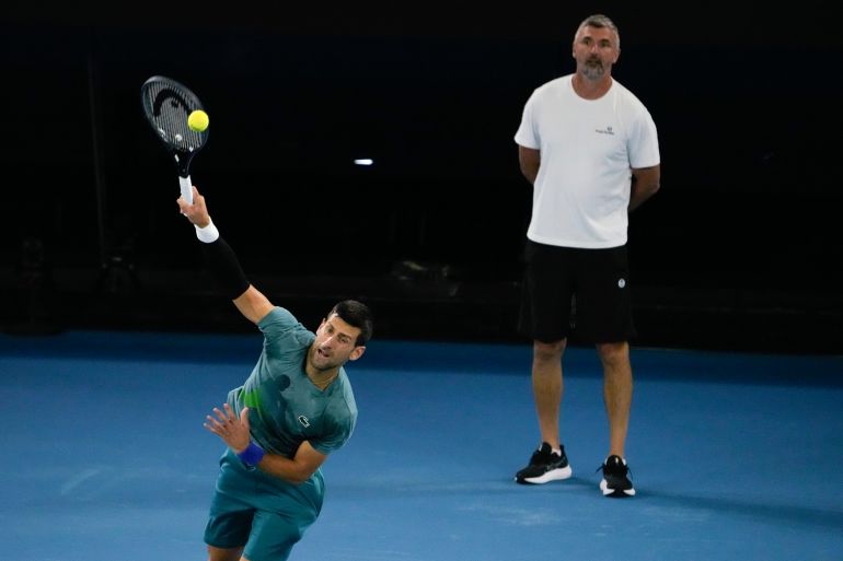 Serbia's Novak Djokovic serves as his coach Goran Ivanisevic watches during a practice session at the 2024 Australian Open tennis championships.