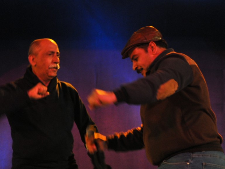 Zakaria dancing on stage with a band member