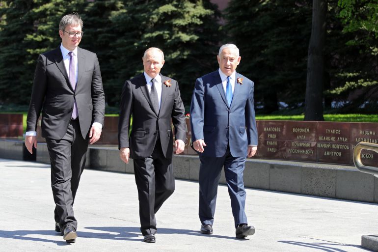 In this image from May 2018, Russian President Vladimir Putin, Prime Minister of Israel Benjamin Netanyahu, and Serbian President Aleksandar Vucic prepare to lay flowers at the Tomb of the Unknown Soldier in Alexander Garden in Moscow