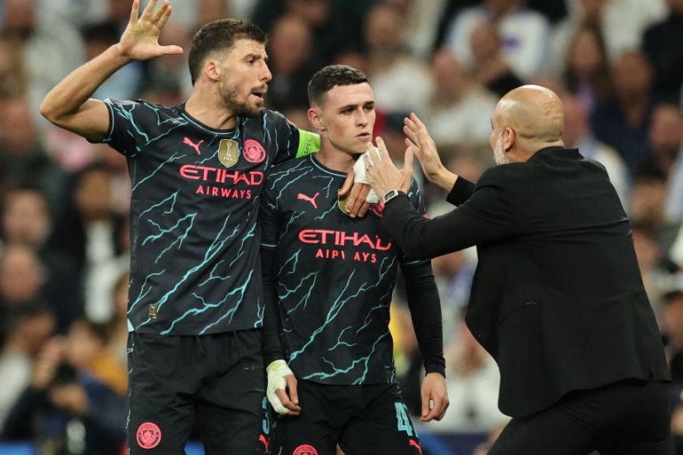 Manchester City's Phil Foden celebrates scoring their second goal with manager Pep Guardiola and Ruben Dias