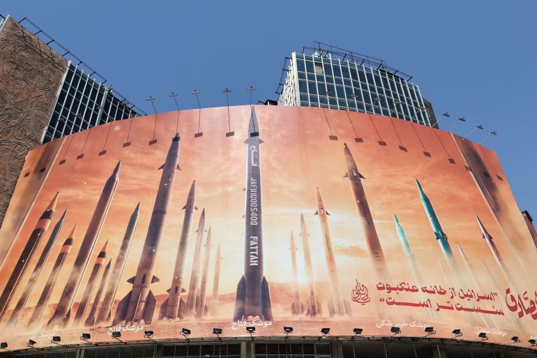An anti-Israel billboard with a picture of Iranian missiles is seen on a street in Tehran