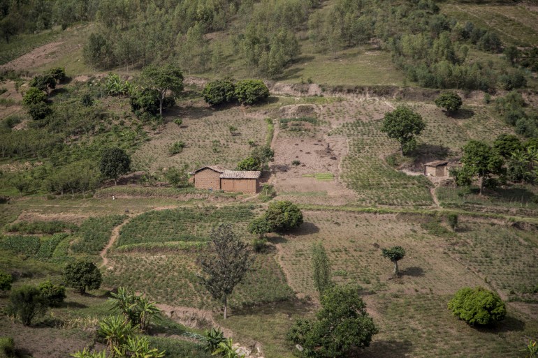 A view of a section of Giheta village as seen from neighbouring Ruseke village on an adjascent hill, across the valley on which sits a common well-spring shared by both villages, at the border between Musambira and Nyarubaka sectors of Kamonyi District on March 4, 2019. Two villages on adjascent hills are re-learning to share all they have, including a well-spring at the bottom of the valley, after 1994 genocide. More than a thousand residents of the town were massacred in the days following the outbreak of inter-ethnic violence, a genocide in which over 800,000 mostly Tutsi people were slaughtered between April to July 1994, according to the UN. (Photo by JACQUES NKINZINGABO / AFP)