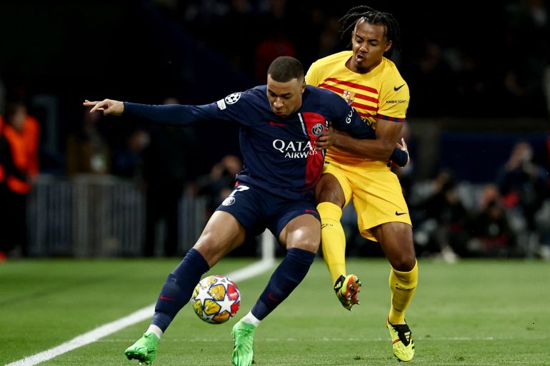 Paris Saint-Germain's French forward #07 Kylian Mbappe (L) and Barcelona's French defender #23 Jules Kounde (R)